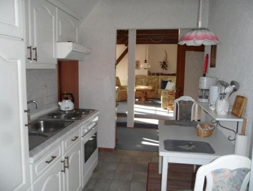a kitchen with a sink and a stove at Unterm-Reetdach-2 in Borkum