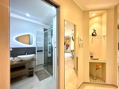 a bathroom with a sink and a mirror at Casa Diana in Sanremo