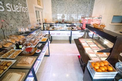a bakery with a bunch of different types of pastries at Hoteles Urbanos N Avenida de España in Fuenlabrada