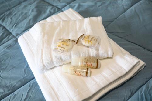 two white towels are sitting on a bed at Domus Antica Trastevere in Rome