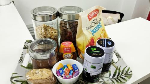a table with various food items on it at Studio Chambre double RDC in Chazelles-sur-Lyon