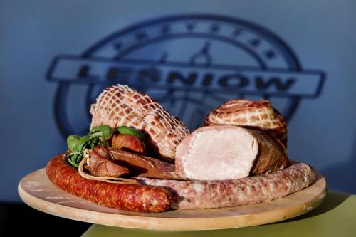 a plate of food with sausage and other foods at Przystań Leśniów in Żarki