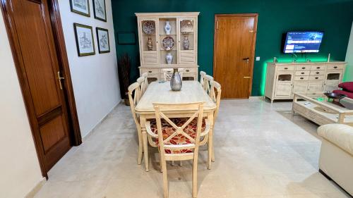 a dining room with a table and chairs at Viña Home in Torre del Mar