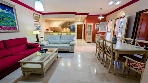 a living room with a couch and a table at Viña Home in Torre del Mar