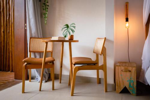 a table and two chairs in a room at Villa Estrela Bungalow in Itacaré