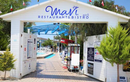 a building with a sign that reads max restaurant and bistro at Mavi Restaurant & Apartments 3 in Didim