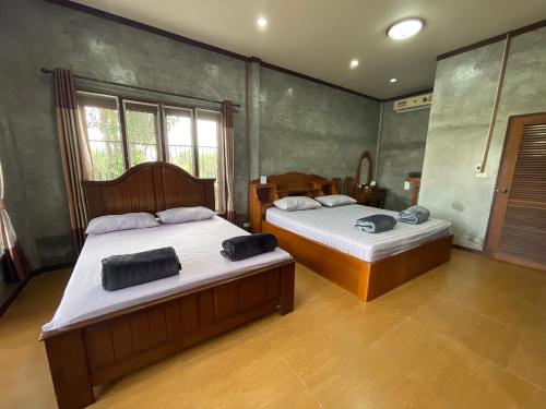 a bedroom with two beds in a room at Yaowarate Sport Club and Resort ไร่เยาวเรศ in Ban Mae Ho Phra