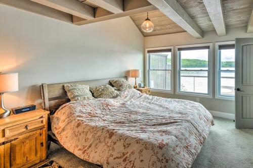 a bedroom with a large bed and windows at Lake Front Enfield Home with Deck & Boat Dock! in Enfield
