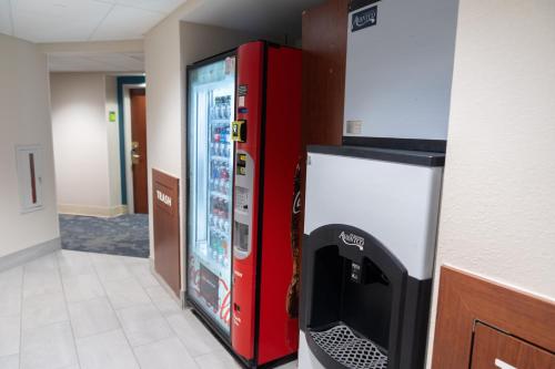 a red refrigerator and a television in a room at La Quinta by Wyndham Bannockburn-Deerfield in Bannockburn