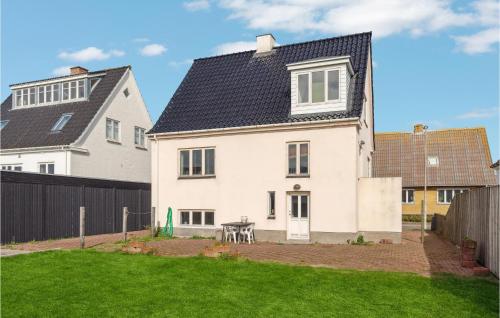 a white house with a black roof at Lovely Home In Thyborøn With Kitchen in Thyborøn