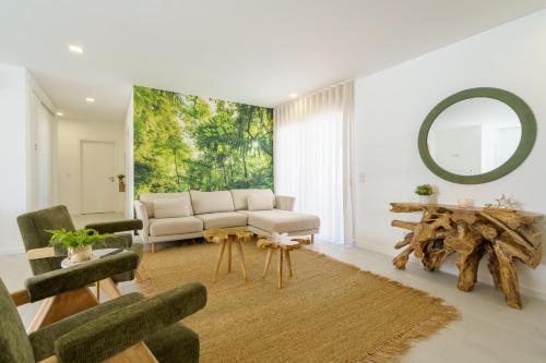 a living room with a couch and a mirror at Villa Lola luxury villa with private pool and jacuzzi in Mariquiteira