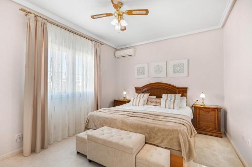 a bedroom with a bed and a ceiling fan at Villa Quesada in Rojales