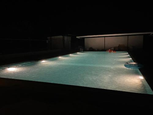 an empty swimming pool with lights in the dark at Yaowarate Sport Club and Resort ไร่เยาวเรศ in Ban Mae Ho Phra