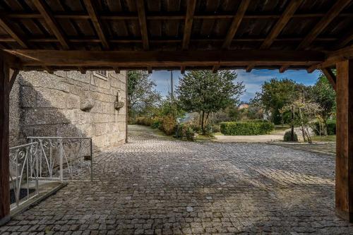 an entrance to a stone building with a gate at Quinta de São Martinho Visconde do Penedo in Soengas