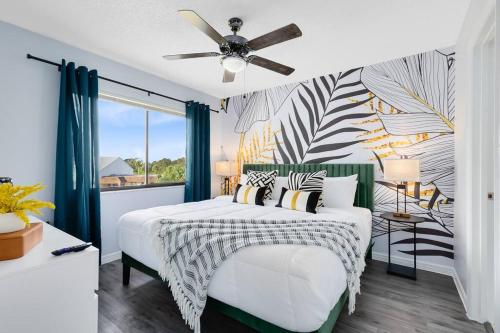 a bedroom with a bed with a ceiling fan at Oasis 317 - Space to Unwind in Titusville