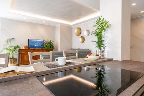 a living room with a table and a couch at Villa Sunrise - Luxury property with pool & large private garden, few steps from the beach, ideal for families and people with mobility issues in Dervio