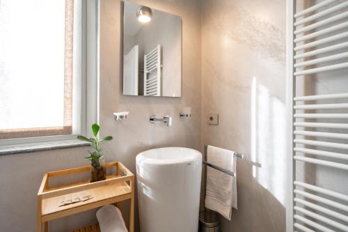 a bathroom with a white toilet and a mirror at Villa Sunrise - Luxury property with pool & large private garden, few steps from the beach, ideal for families and people with mobility issues in Dervio