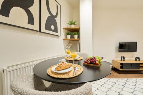 a room with a table with a bowl of fruit at Compact & Stylish Studios in Central Brussels in Brussels