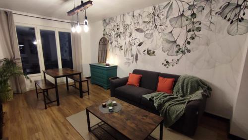 a living room with a couch and a table at Le Céladon in Dijon