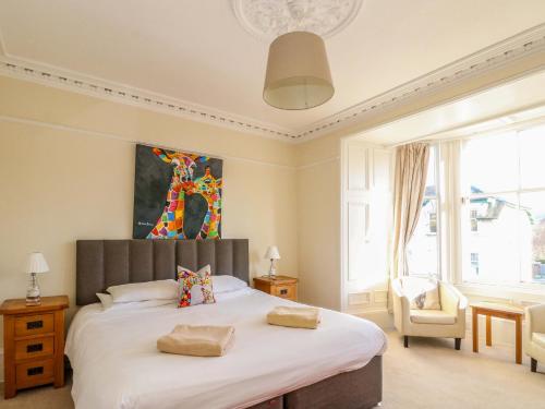 a bedroom with a large bed with two pillows on it at Tayview in Killin