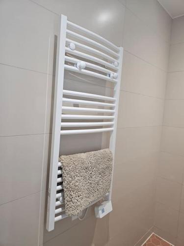 - un porte-serviettes blanc dans la salle de bains blanche dans l'établissement chic Montmartre apartment, à Paris