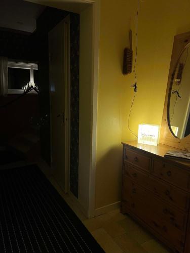 a bathroom with a dresser and a mirror and a dresser at Strandvägen 6A Ragnhild in Järvsö