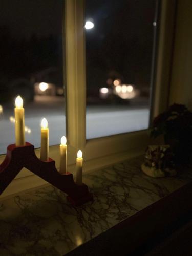 a group of candles sitting in front of a window at Strandvägen 6A Ragnhild in Järvsö