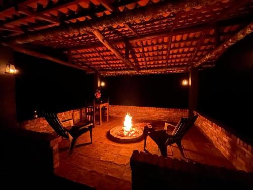 a patio with two chairs and a fire pit at El Agrado Restaurante Cabañas in Líbano