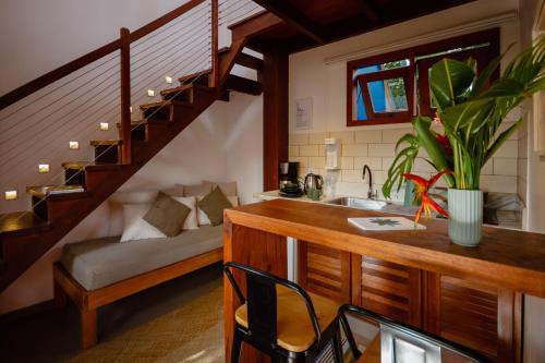 a kitchen with a sink and a staircase in a room at Villa Estrela Bungalow in Itacaré