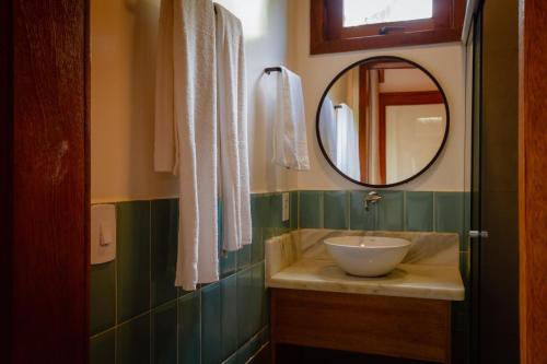 a bathroom with a sink and a mirror at Villa Estrela Bungalow in Itacaré