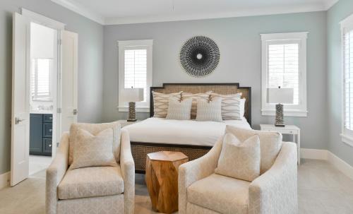 a bedroom with a bed and two chairs at Lagoon View 3 Bedroom Moreland Village Home 5602 in Bluffton