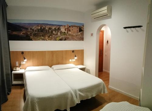 A bed or beds in a room at Hostal Restaurante Cornella
