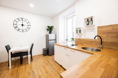 cocina con fregadero, mesa y nevera en Appartamento Tanja Trieste, en Trieste