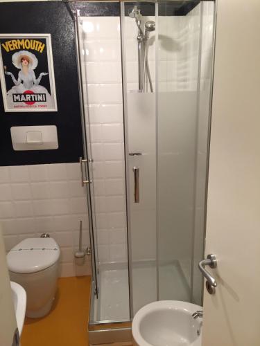 a bathroom with a shower with a toilet and a sink at Duomo House in Milan