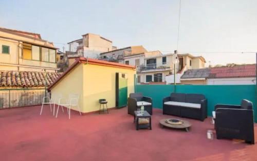 a patio with couches and a table on a roof at La Timpa house in Satriano