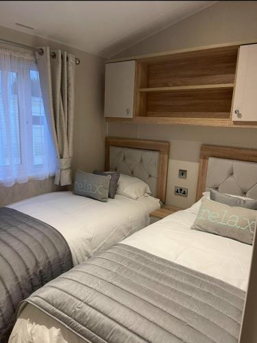 two beds sitting next to each other in a bedroom at 14 morningside in Skegness