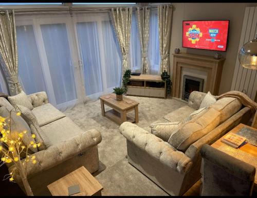a living room with two couches and a tv at 14 morningside in Skegness