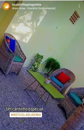 two wicker chairs and a table with a plant at Village Lagoinha Ceará in Tigre