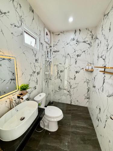a bathroom with a white toilet and a sink at Dream pool villa 3 in Bang Sare