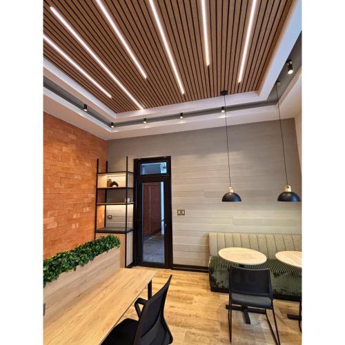 a room with a table and two chairs and a ceiling with lights at Sori Apartments in Lima