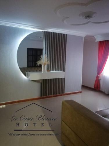 a living room with a mirror and a couch at La Casa Blanca Hotel in Buenaventura