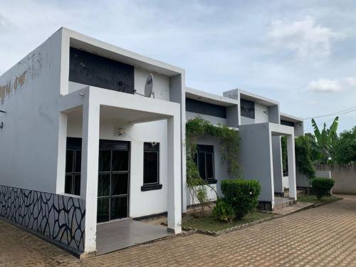 a white building with a lot of windows at House of Light in Arua