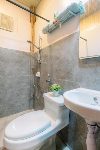 a bathroom with a toilet and a sink at Busai Dream Falls Resort in Loboc