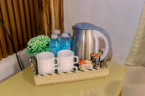 a basket with cups and water bottles on a table at Busai Dream Falls Resort in Loboc