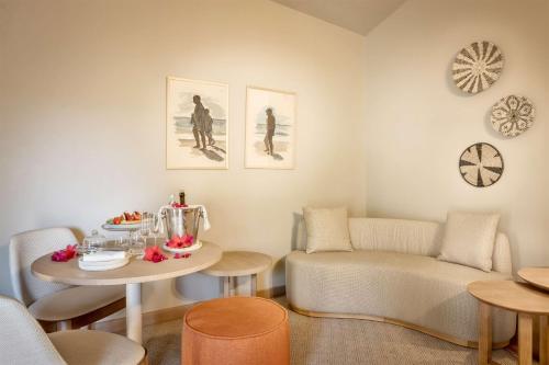 a living room with a couch and a table at Veridia Resort Sardinia, a member of Radisson Individuals in Chia