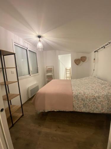 a bedroom with a bed and a ladder in it at Appartement COSY in Sartilly