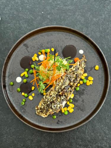 a plate of food with vegetables on a table at Natur & Familienhotel Der Stieglerhof in Radstadt