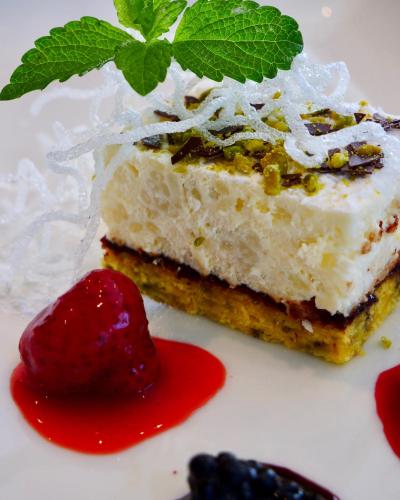 a piece of cake with a strawberry on a plate at Natur & Familienhotel Der Stieglerhof in Radstadt