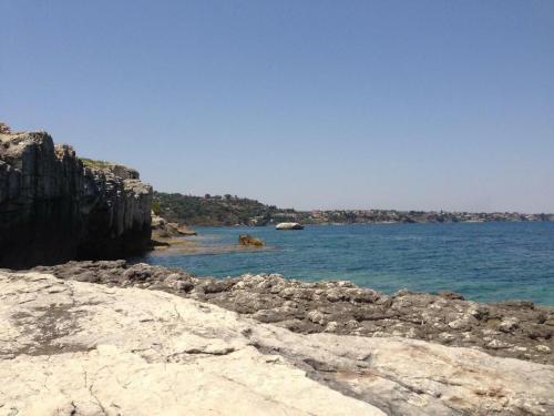 a body of water with rocks in the water at Casa del Mar, Brucoli in Siracusa