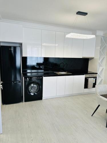 a kitchen with a black refrigerator and a dishwasher at Danielis Apartament in Velingrad